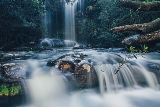 Full flowing waterfall and cascades in Royal National Park. National Falls is just a short walk from the small carpark. Just beyond the cascades is another 30 meter cliff drop