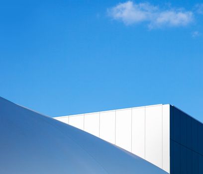 Modern fragment on a construction building, against blue sky, Sunny day