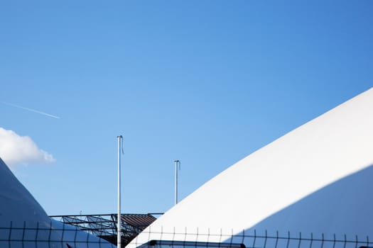 Modern fragment on a construction building, against blue sky, Sunny day