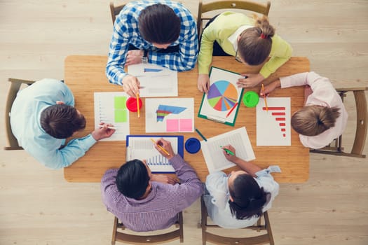 Business team meeting, people in casual clothes working with financial statistics at office desk