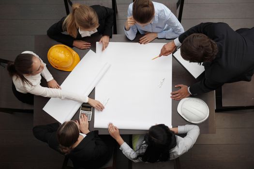 Top view of people around table in construction business meeting