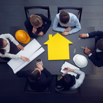 Top view of people around table in construction business meeting