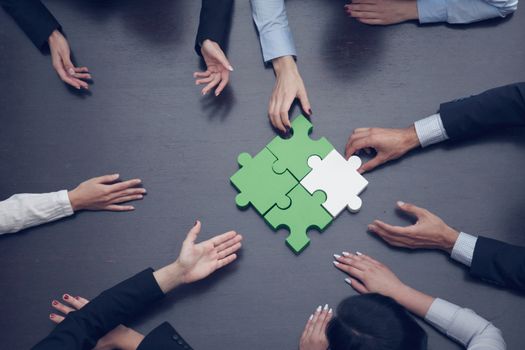 Group of business people assembling jigsaw puzzle, team support and help concept