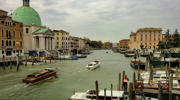 View of venice from the bridge in front of the train station on a cloudy day.