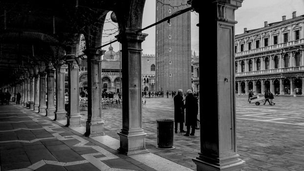 View of Piazza San Marco in Venice in a historical photo of many years ago, half-empty square and very striking with high contrast. Black and white shot.