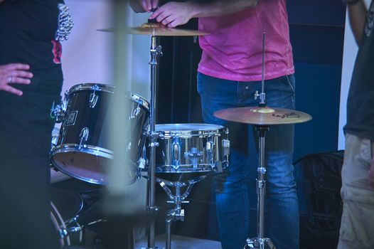 View of a drums, musical instrument, from the point of view of the player, shot in a stage ready for a live concert of a rock band.