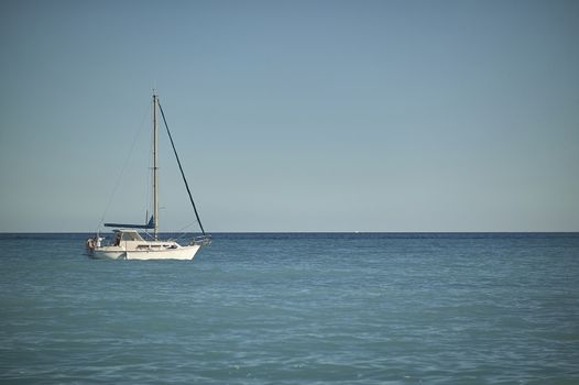 Beautiful sailing boat while sailing in the sea near the coast ready to dock.