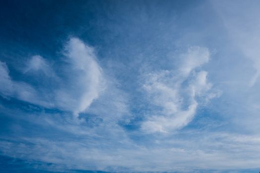 beautiful background of clouds, clearly visible lines of white clouds and blue sky, the top is a sunbeam