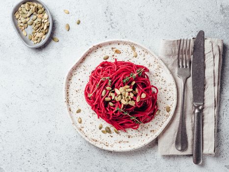 Beetroot pesto or hummus. Homemade beet pesto sauce in glass jar and fresh thyme on dark black background. Copy space for text. Ideas and recipes for healthy vegetarian detox diet food