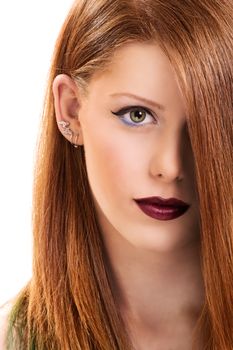 Close up portrait of a beautiful young woman with make up with hair covering her eye, isolated on white background.