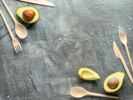 Avocado Seeds Biodegradable Single-Use Cutlery. Bioplastic - Great alternative to plastic disposable cutlery. Top view, flat lay. Gray background