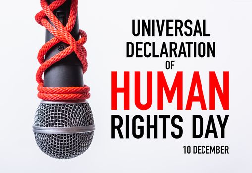 Red Rope and chain on fist hand with world HUMAN RIGHTS DAY 10 DECEMBER text on white background, Human rights day concept