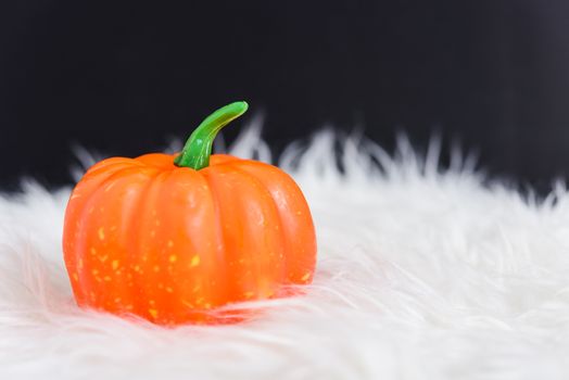 Orange pumpkin in Halloween day concept on black background