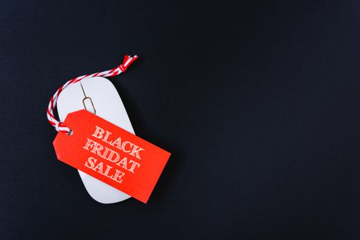 Online shopping Black Friday sale text red tag on white mouse with black background