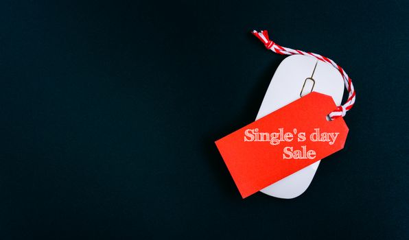 Online shopping Single's day sale text red tag on computer mouse with black background