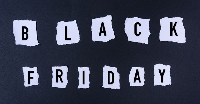 Black Friday words text into white paper torn on black background