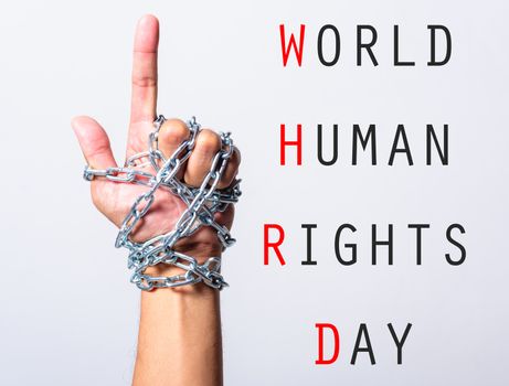 Chained fist hand point finger with WORLD HUMAN RIGHTS DAY text on white background, Human rights day concept