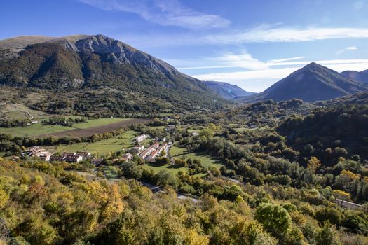 landscape of a sunny valley and mountain peaks as seen from the town of Opi, in Abruzzo national park, Italy
