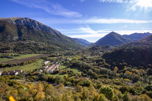 landscape of a sunny valley and mountain peaks as seen from the town of Opi, in Abruzzo national park, Italy