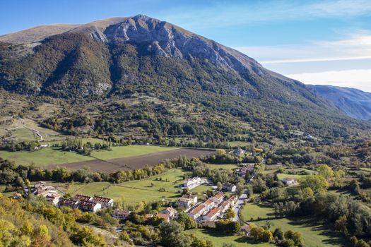 landscape of a sunny valley and mountain peaks as seen from the town of Opi, in Abruzzo national park, Italy
