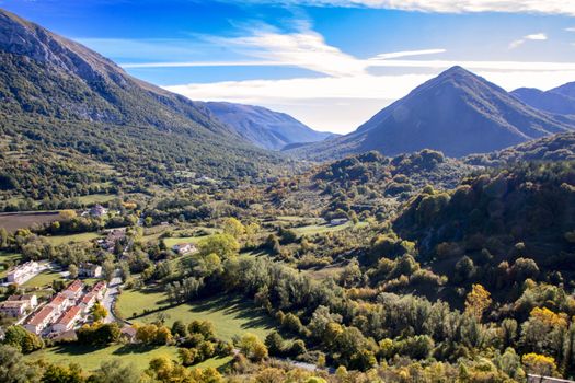 landscape of a sunny valley and mountain peaks as seen from the town of Opi, in Abruzzo national park, Italy