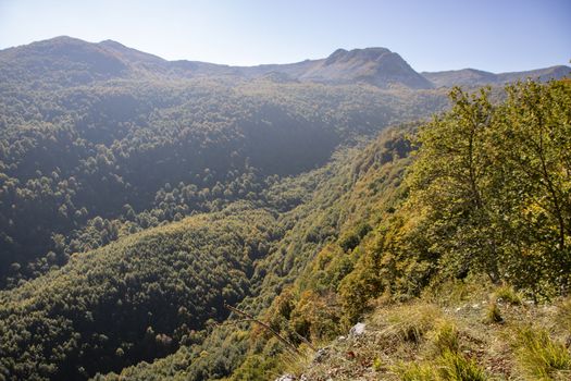 landscape of a sunny valley and mountain peaks as seen from the town of Opi, in Abruzzo national park, Italy