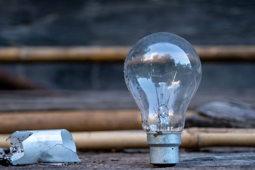 The Light bulb standing on wood - Concept of saving energy and have a big idea.