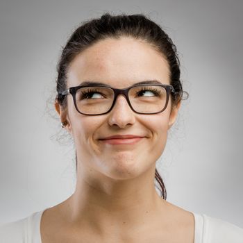 Cute portrait of a happy woman thinking 