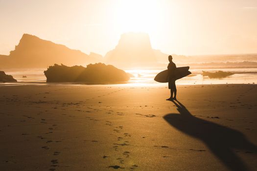 Surfer checking the waves at sunset