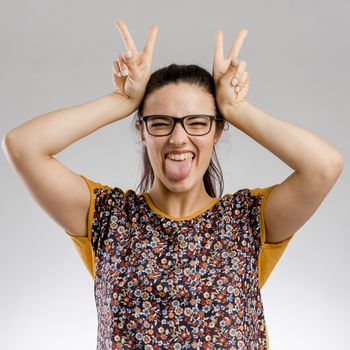 Funny portrait of woman making rabbit ears