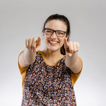 Happy woman smiling and pointing to the camera