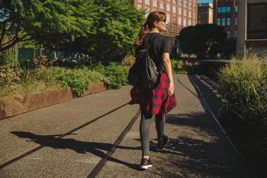 Beautiful woman walking on the HighLine Park, NYC