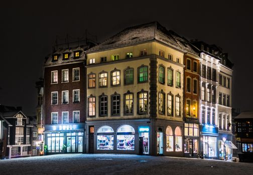Snowy empty street at night in Aachen, Germany - lights and reflections