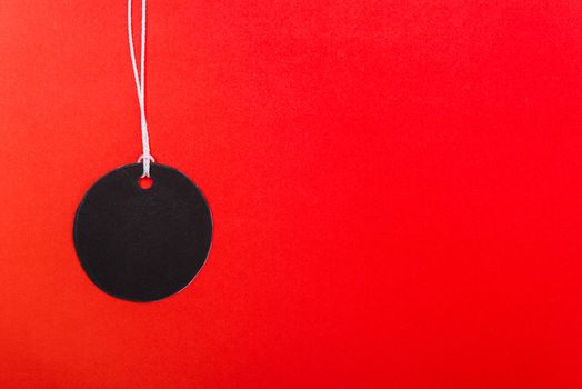 Circle Black tag label on red background, with copy space