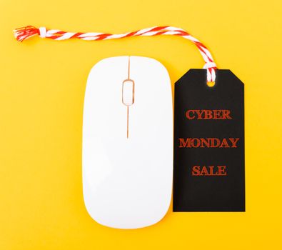 Online shopping Cyber Monday sale text red tag on white mouse with yellow background