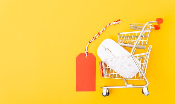 Blank red tag label have white mouse on cart shopping, with copy space on yellow background