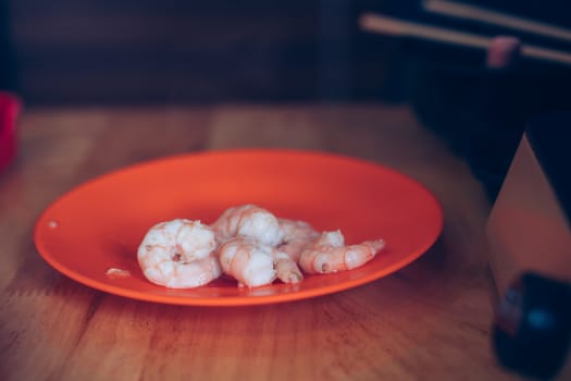 The Boiled Shrimp. A pile of orange boiled shrimp peeled with tails still attached ready to eat