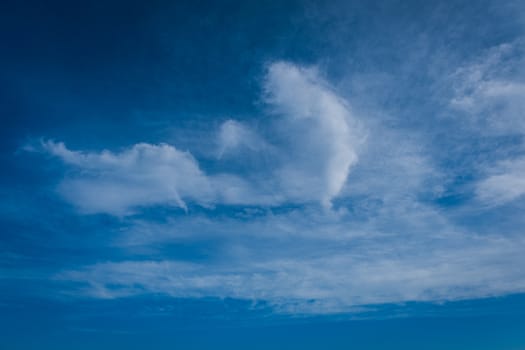 The beautiful background of clouds, clearly visible lines of white clouds and blue sky, the top is a sunbeam