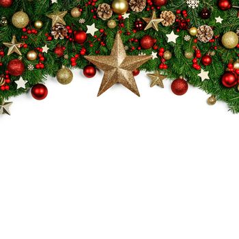 Christmas Border frame of tree branches around white background with copy space isolated, red and golden decor, berries, stars, cones