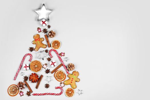 Christmas Tree made of food and decor on white paper background. Christmas Holiday Concept. Flat Lay