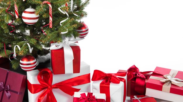 Decorated Christmas tree and gift boxes isolated on white background