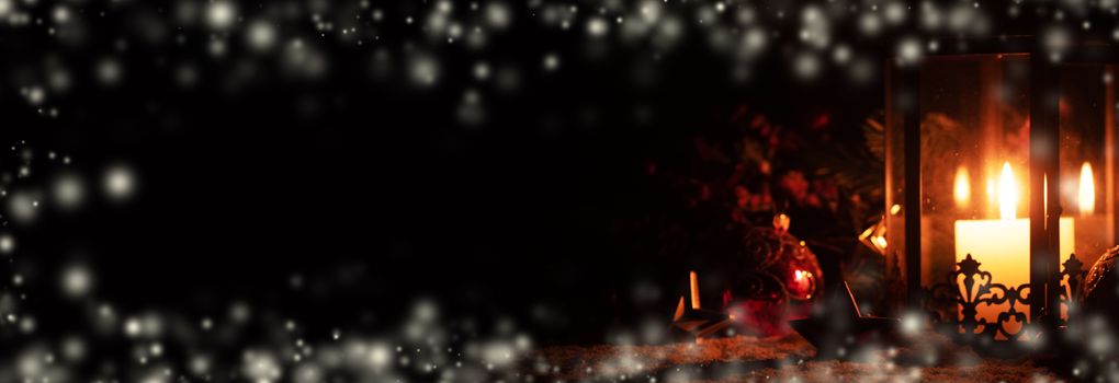 Christmas lantern glowing in dark with stars on snow