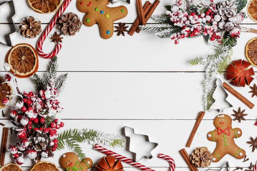 Christmas food frame. Gingerbread cookies, spices and decorations on white table background with copy space