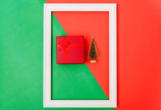 New Year, Christmas Xmas holiday composition, Top view gift red box, clews of rope, green fir tree branch on red and green background with copy space