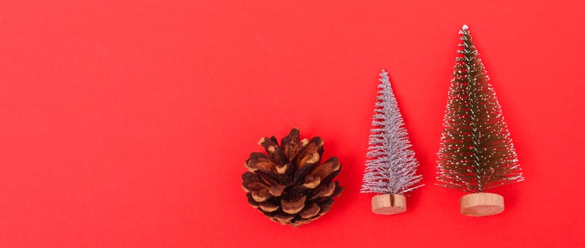 New Year, Christmas Xmas holiday composition, Top view green fir tree branch on red background with copy space