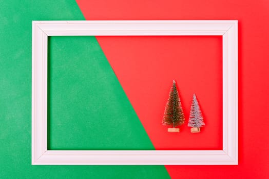 New Year, Christmas Xmas holiday composition, Top view both green fir tree branch in frame on red and green background with copy space