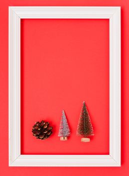 New Year, Christmas Xmas holiday composition, Top view green fir tree branch in frame on red background with copy space