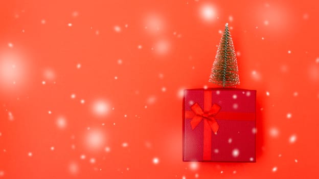 New Year, Christmas Xmas holiday composition, Top view red gift box with green fir tree branch over box on red background with copy space
