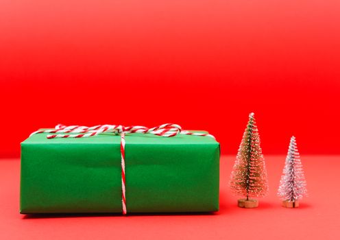 New Year, Christmas Xmas holiday composition, Top view green gift box and green fir tree branch on red background