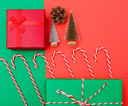 New Year, Christmas Xmas holiday composition, Top view with gift box, clews of rope, green fir tree branch on red and green background with copy space